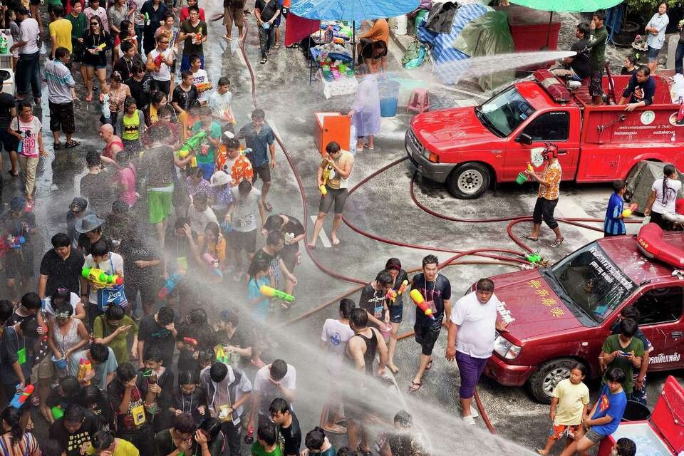Firetruck spraying water on crowds during Songkran