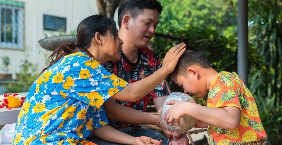 Family performing rod nam dam huua ceremony