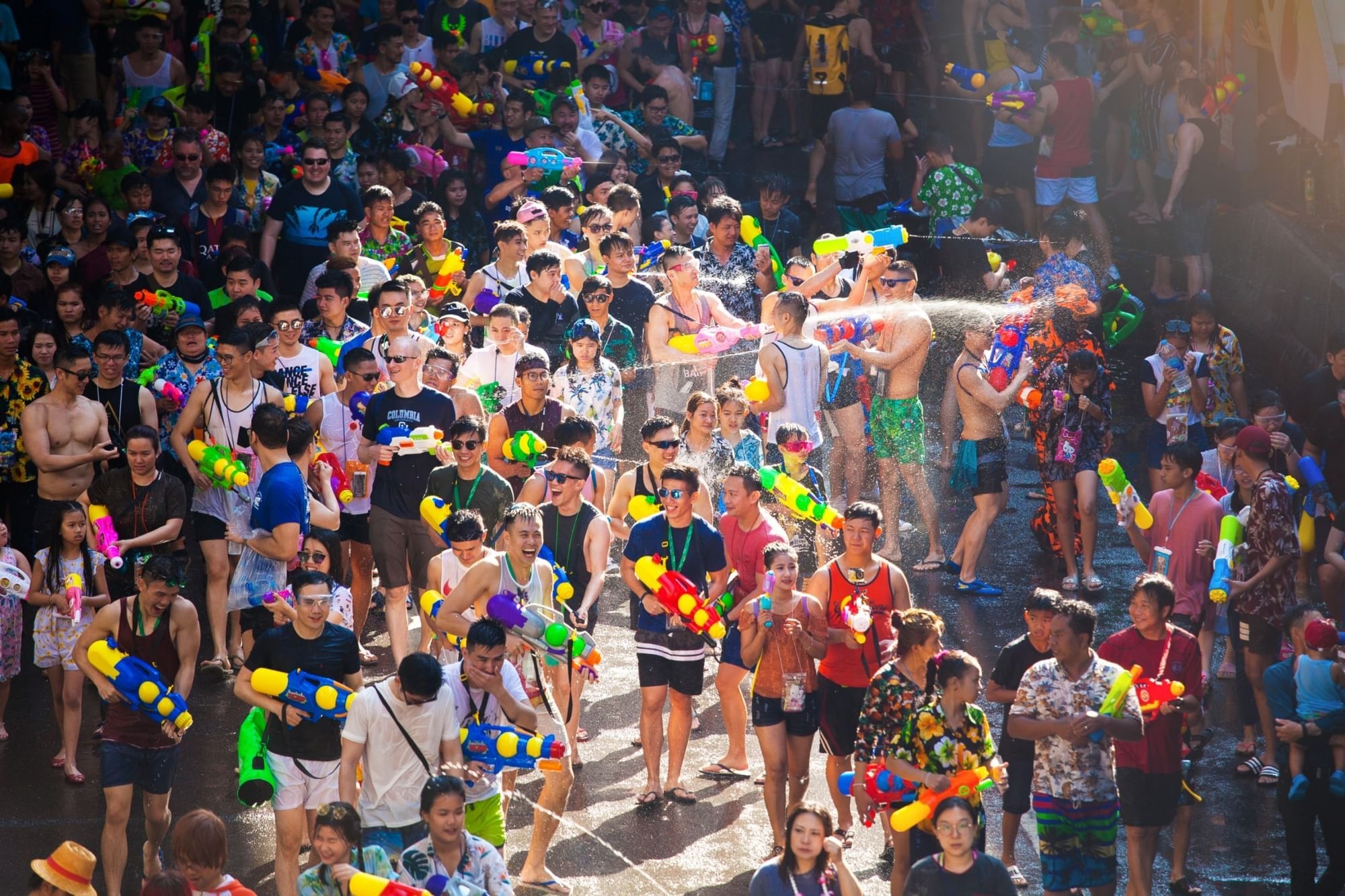 Crowds celebrating Songkran in Silom Road with a splash!