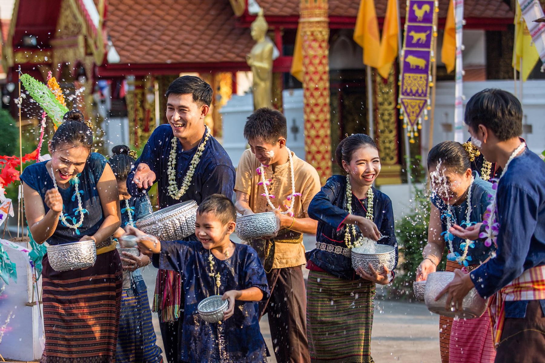gentle water fight in a traditional Songkran setting